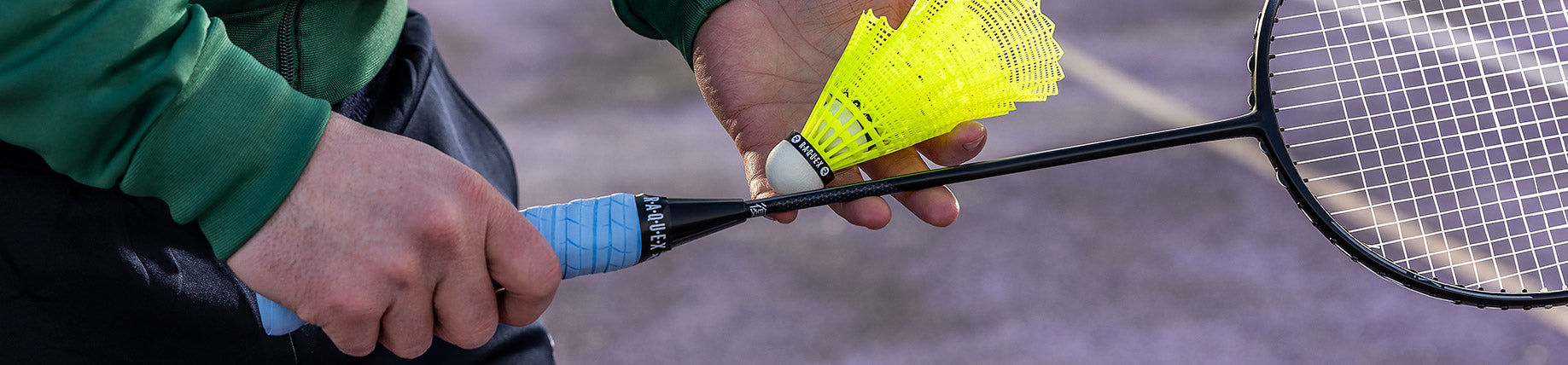 A man playing badmington with a raquex shuttlecock