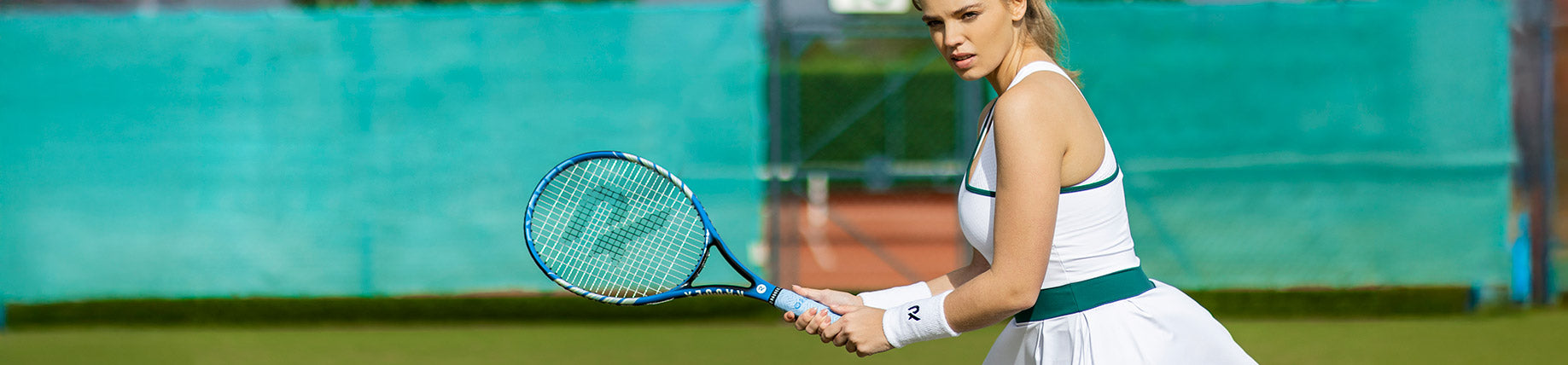 A lady playing tennis with a Raquex tennis racket
