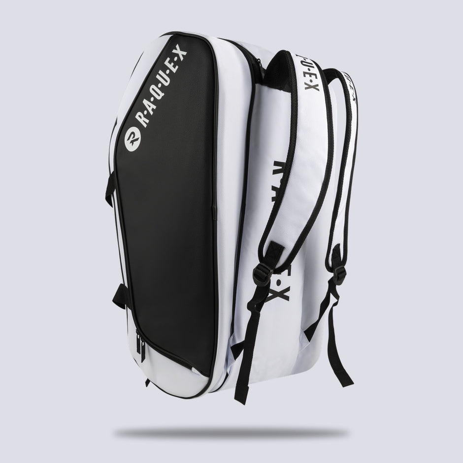 White Raquex Execute Tour padel bag stood upright, showing depth and the shoulder strap fixings