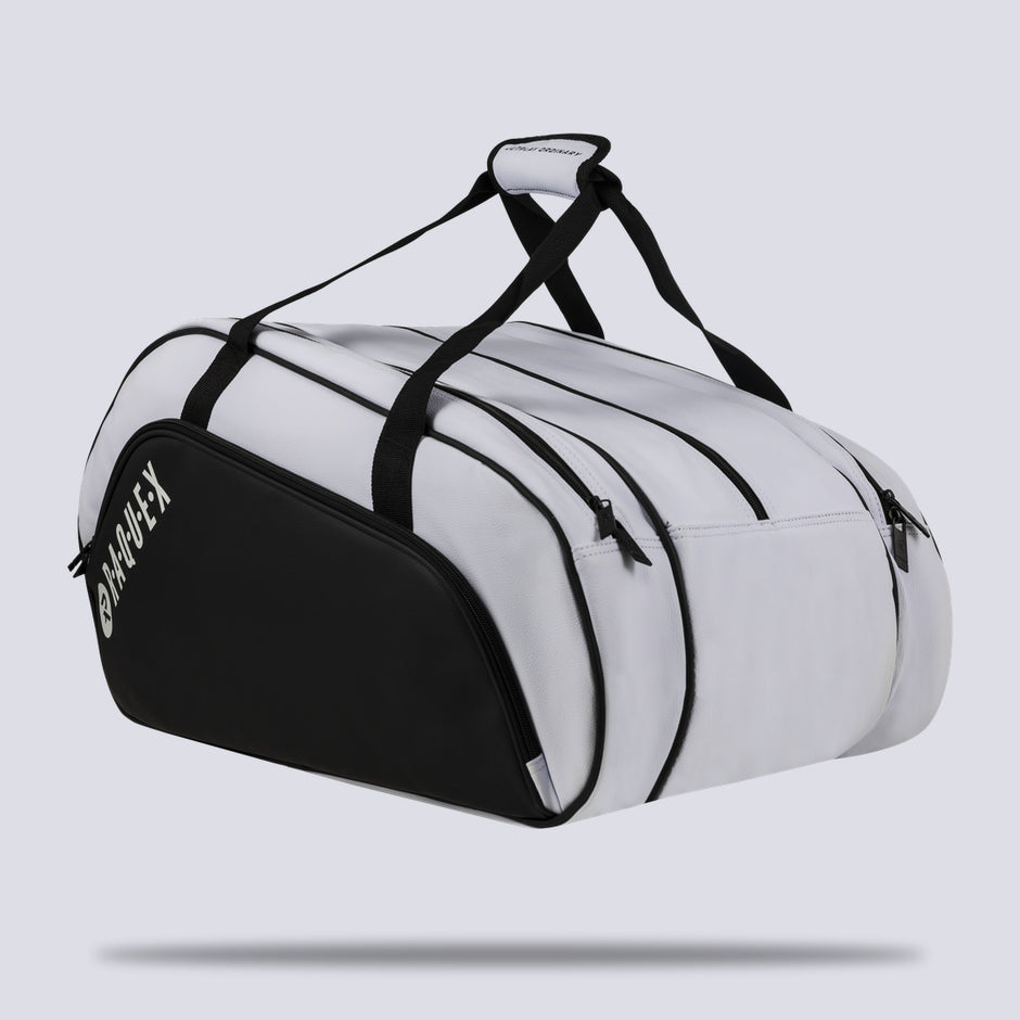Rear three-quarter view of the white Raquex Execute Tour padel bag showing the full zip layout