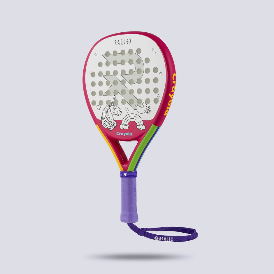 Raquex x Crayola junior padel racquet in pink at an angle, unicorn face, showing the cushioned grip and fitted wrist strap