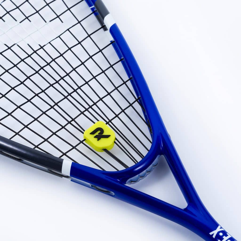 Raquex yellow tennis string dampener installed on a blue Raquex tennis racquet